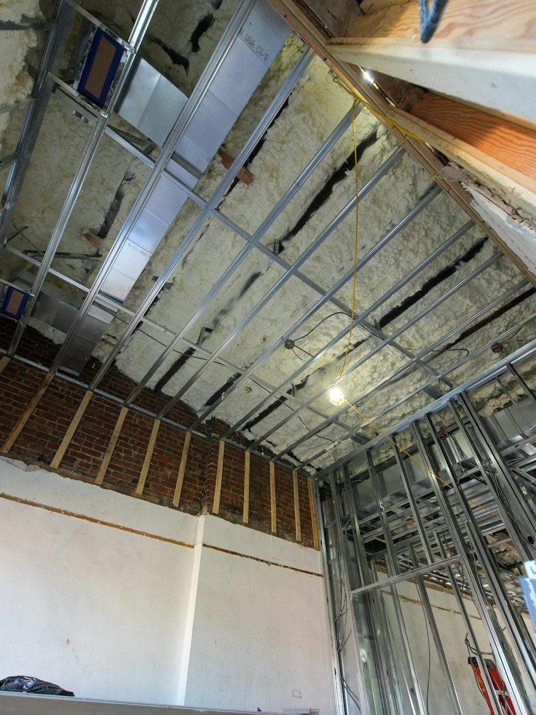 portfolio-05 A three-story brownstone stands in mid-transformation, captured at the raw and honest “before” stage of a full interior renovation. These images document a moment that usually disappears once the walls are closed and the finishes are installed — exposed framing, stripped ceilings, rough staircases, and open corridors that reveal the building’s original structure and hidden history. Light spills in through skylights and tall windows, cutting through layers of dust and unfinished surfaces, creating a quiet contrast between decay and renewal. The space feels both industrial and intimate: narrow