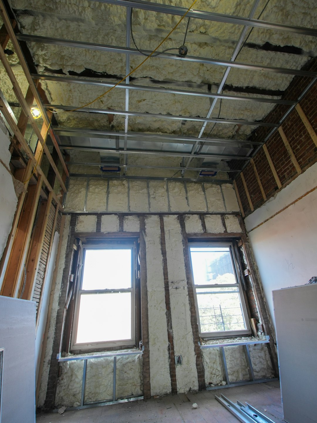 portfolio-04 A three-story brownstone stands in mid-transformation, captured at the raw and honest “before” stage of a full interior renovation. These images document a moment that usually disappears once the walls are closed and the finishes are installed — exposed framing, stripped ceilings, rough staircases, and open corridors that reveal the building’s original structure and hidden history. Light spills in through skylights and tall windows, cutting through layers of dust and unfinished surfaces, creating a quiet contrast between decay and renewal. The space feels both industrial and intimate: narrow