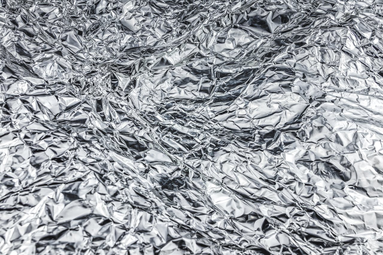 Close-up of crumpled aluminum foil creating a shiny, textured surface.